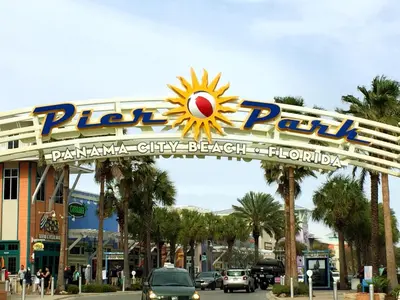 a sign over a street in front of a building at Beachfront Panama City Condo Walk to Pier Park! in Panama City Beach