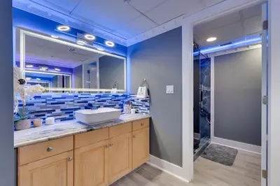 a bathroom with a sink and a mirror at Community Perks! Luxury Panama City Beach Condo in Panama City Beach