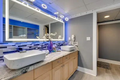 a bathroom with two sinks and a large mirror at Community Perks! Luxury Panama City Beach Condo in Panama City Beach