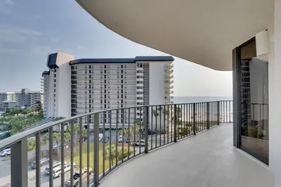 a balcony with a view of a building at Community Perks! Luxury Panama City Beach Condo in Panama City Beach