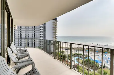 a balcony with chairs and a view of the beach at Community Perks! Luxury Panama City Beach Condo in Panama City Beach