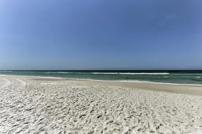 a sandy beach with the ocean in the background at Coastal Florida Abode with Pool Access and Ocean Views in Panama City Beach