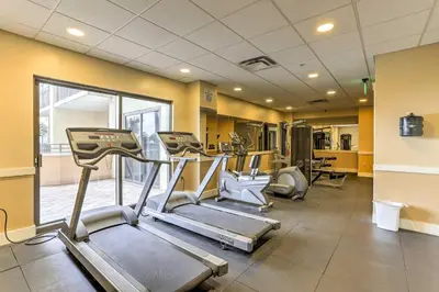 a gym with treadmills and machines in a room at Coastal Florida Abode with Pool Access and Ocean Views in Panama City Beach