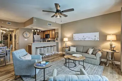 a living room with a couch and a table at Resort Pool, Gym and Hot Tub Beachfront PCB Condo! in Panama City Beach