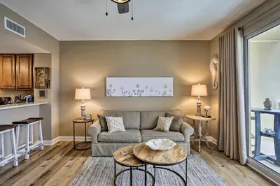 a living room with a couch and a table at Resort Pool, Gym and Hot Tub Beachfront PCB Condo! in Panama City Beach
