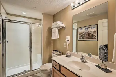a bathroom with a shower and a sink and a toilet at Resort Pool, Gym and Hot Tub Beachfront PCB Condo! in Panama City Beach