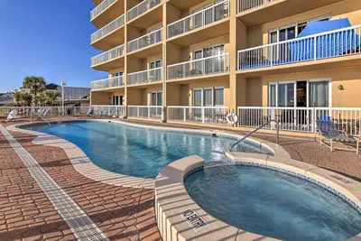 a swimming pool in front of a building at Resort Pool, Gym and Hot Tub Beachfront PCB Condo! in Panama City Beach