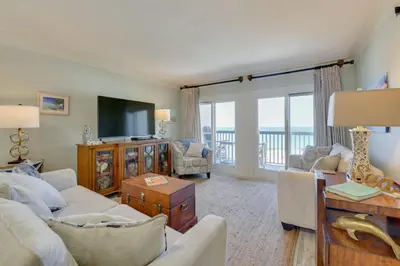 a living room with a couch and a tv at Oceanfront PCB Condo with Beach Access and 2 Pools in Panama City Beach