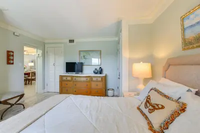 a bedroom with a bed with a television and a dresser at Oceanfront PCB Condo with Beach Access and 2 Pools in Panama City Beach