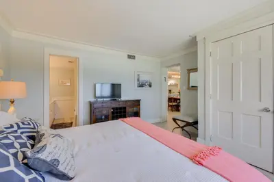 a bedroom with a large bed and a television at Oceanfront PCB Condo with Beach Access and 2 Pools in Panama City Beach