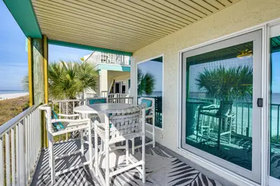 a balcony with a table and chairs on the beach at Oceanfront Panama City Beach Condo with Balcony! in Panama City Beach