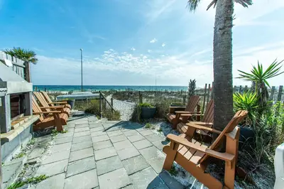 a patio with chairs and a table and the beach at Klaus House 1 in Panama City Beach