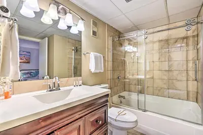 a bathroom with a sink and a shower and a toilet at Chic PCB Condo with Pool Access and Beachfront Balcony in Panama City Beach