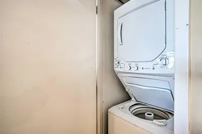 a washer and dryer in a small room at Chic PCB Condo with Pool Access and Beachfront Balcony in Panama City Beach