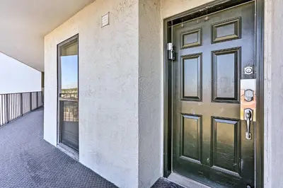a door on a building with a balcony at Chic PCB Condo with Pool Access and Beachfront Balcony in Panama City Beach