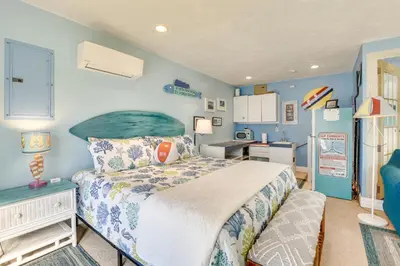 a small bedroom with a bed and a kitchen at PCB Studio with Private Patio Steps to Beach! in Panama City Beach