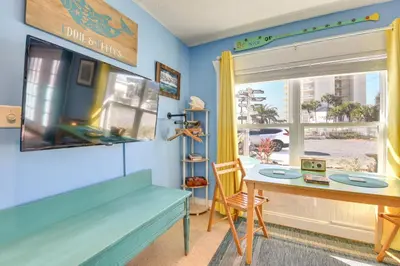 a room with a table and a window and a desk at PCB Studio with Private Patio Steps to Beach! in Panama City Beach