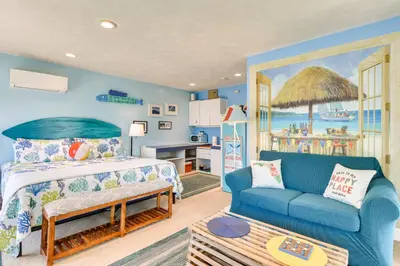 a living room with a bed and a couch at PCB Studio with Private Patio Steps to Beach! in Panama City Beach