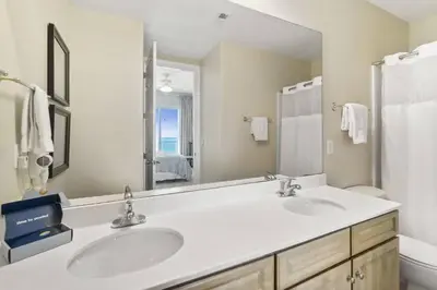a bathroom with two sinks and a large mirror at Ocean Ritz 2101 (4/4) in Panama City Beach