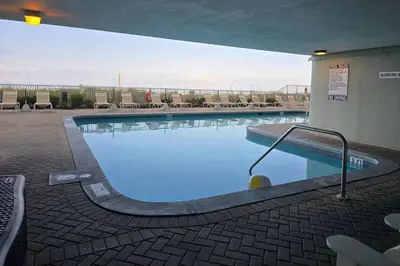 a large swimming pool with blue water in a building at Ocean Ritz 2101 (4/4) in Panama City Beach