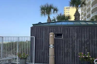 a wooden fence with a pole in front of a building at Ocean Ritz 2101 (4/4) in Panama City Beach
