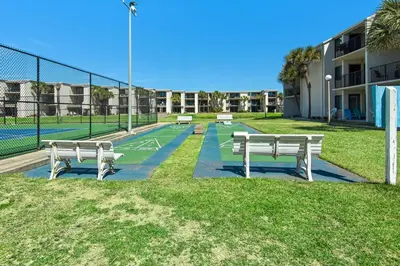two benches on a tennis court in a park at Sugar Beach C-17 (2/2) in Panama City Beach