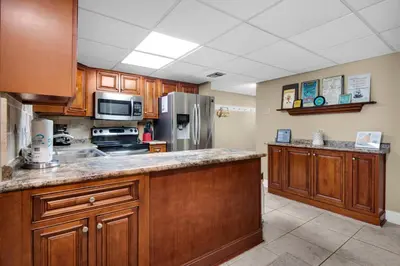 a kitchen with wooden cabinets and stainless steel appliances at Sugar Beach C-17 (2/2) in Panama City Beach