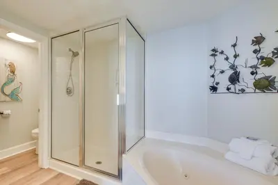a bathroom with a shower and a bath tub at Resort Amenities Beachfront Panama City Condo! in Panama City Beach
