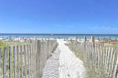 a path through the sand on the beach at Resort Amenities Beachfront Panama City Condo! in Panama City Beach