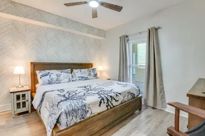 a bedroom with a bed and a window at Resort Amenities Beachfront Panama City Condo! in Panama City Beach