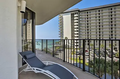 a balcony with a chair and a view of a parking lot at Panama City Beach Condo with Balcony and Ocean Views in Panama City Beach