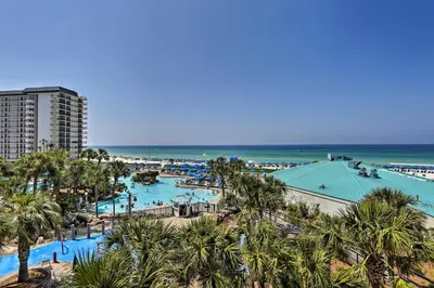 a view of a resort with a pool and the ocean at Panama City Beach Condo with Balcony and Ocean Views in Panama City Beach