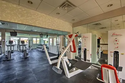 a gym with treadmills and machines in a room at Panama City Beach Condo with Balcony and Ocean Views in Panama City Beach