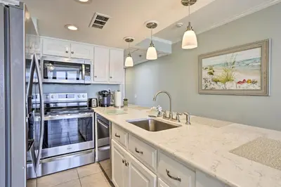 a kitchen with white cabinets and a sink at Bright PCB Condo with Gulf Views and Beach Access! in Panama City Beach