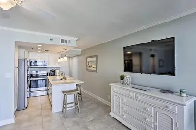 a kitchen with a large tv on the wall at Bright PCB Condo with Gulf Views and Beach Access! in Panama City Beach