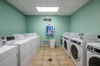 a laundry room with white washing machines and green walls at Bright PCB Condo with Gulf Views and Beach Access! in Panama City Beach