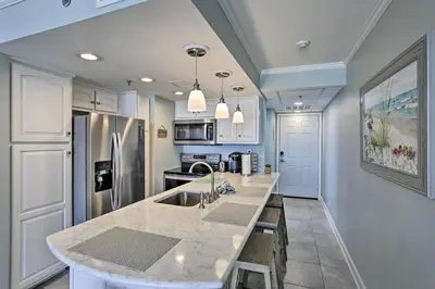 a kitchen with white cabinets and a counter top at Bright PCB Condo with Gulf Views and Beach Access! in Panama City Beach
