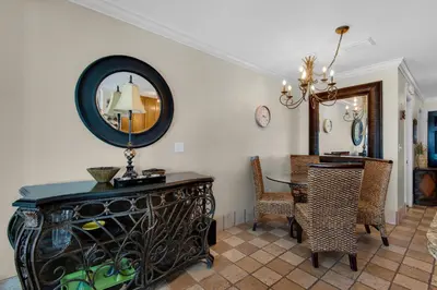 a dining room with a table and a mirror at Klaus House 3 in Panama City Beach