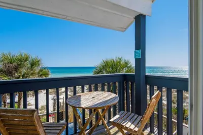 a table and chairs on a balcony with the beach at Klaus House 3 in Panama City Beach