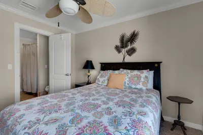 a bedroom with a bed and a ceiling fan at Klaus House 3 in Panama City Beach
