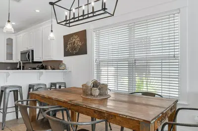 a dining room with a wooden table and chairs at Panama City Beach House - Sunnyside Up in Panama City Beach