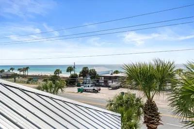 a view of the beach from the balcony of a beach house at Panama City Beach House - Sunnyside Up in Panama City Beach