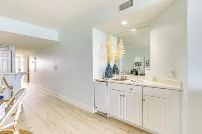 a white bathroom with a sink and a mirror at Gulf Views! 9th-Floor Majestic Beach Resort Condo in Panama City Beach