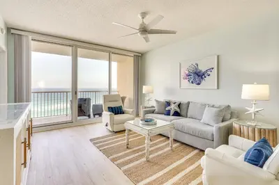 a living room with a couch and a table at Gulf Views! 9th-Floor Majestic Beach Resort Condo in Panama City Beach