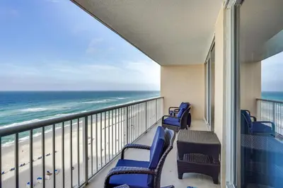 a balcony with chairs and a view of the ocean at Gulf Views! 9th-Floor Majestic Beach Resort Condo in Panama City Beach