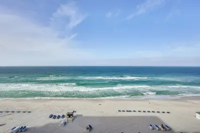 an overhead view of a beach with chairs and the ocean at Gulf Views! 9th-Floor Majestic Beach Resort Condo in Panama City Beach