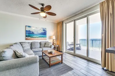 a living room with a couch and a ceiling fan at High-Rise PCB Condo with Oceanfront Views and Pool! in Panama City Beach