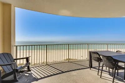 a balcony with a table and chairs and the ocean at High-Rise PCB Condo with Oceanfront Views and Pool! in Panama City Beach