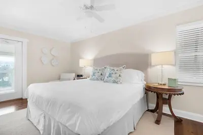 a white bedroom with a large bed and a table at Double Down in Santa Rosa Beach