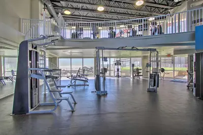 a gym with treadmills and equipment in a building at Comfy PCB Condo with View and Private Beach Access! in Panama City Beach